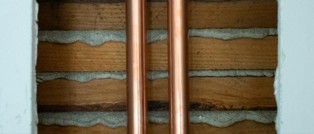 Copper supply pipes running through an open wall
