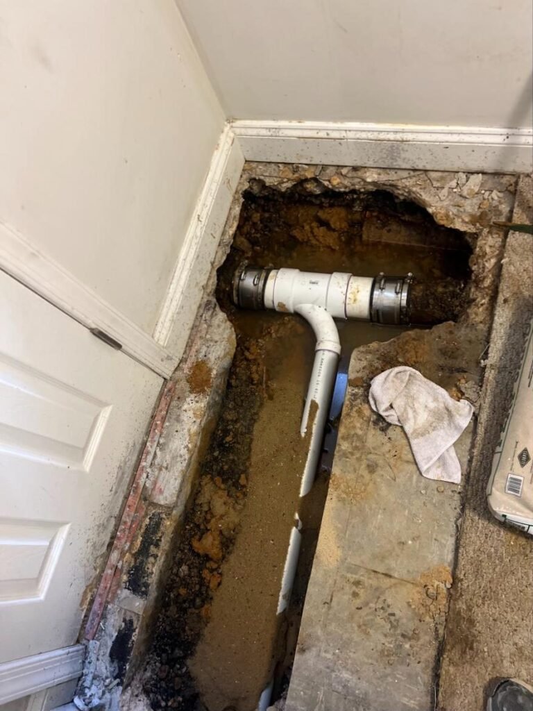 Section of under-slab drain line replaced with new PVC