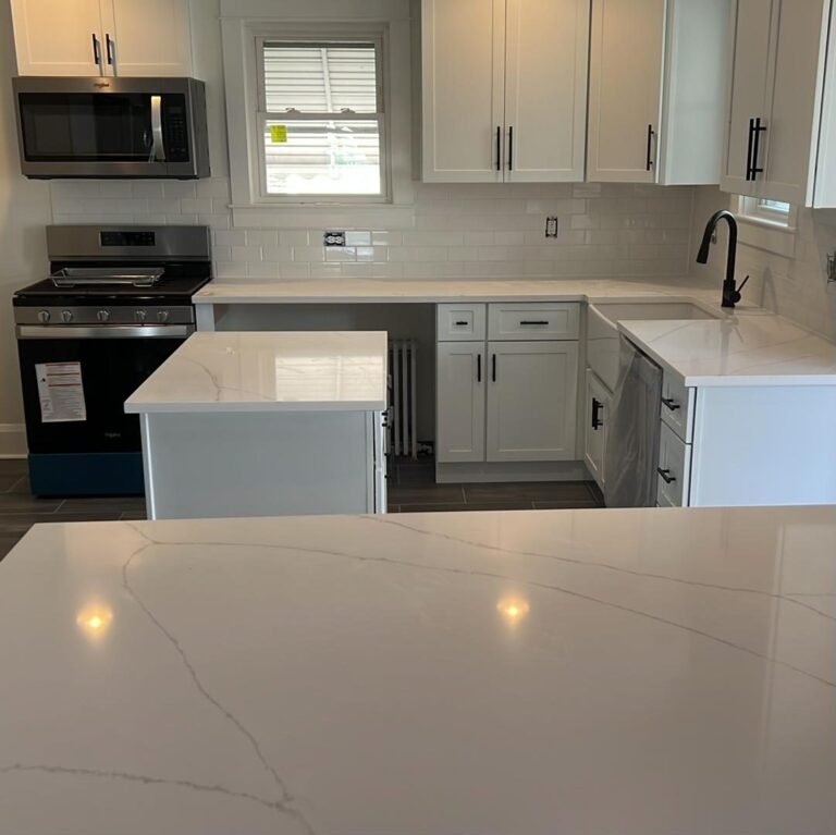 Kitchen remodel with white cabinets, quartz counters and black faucet