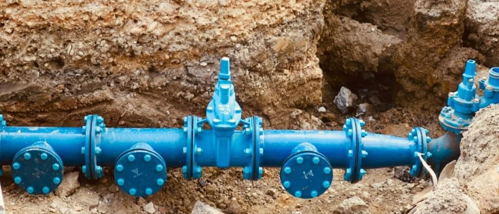 Blue water main with valves in an open trench